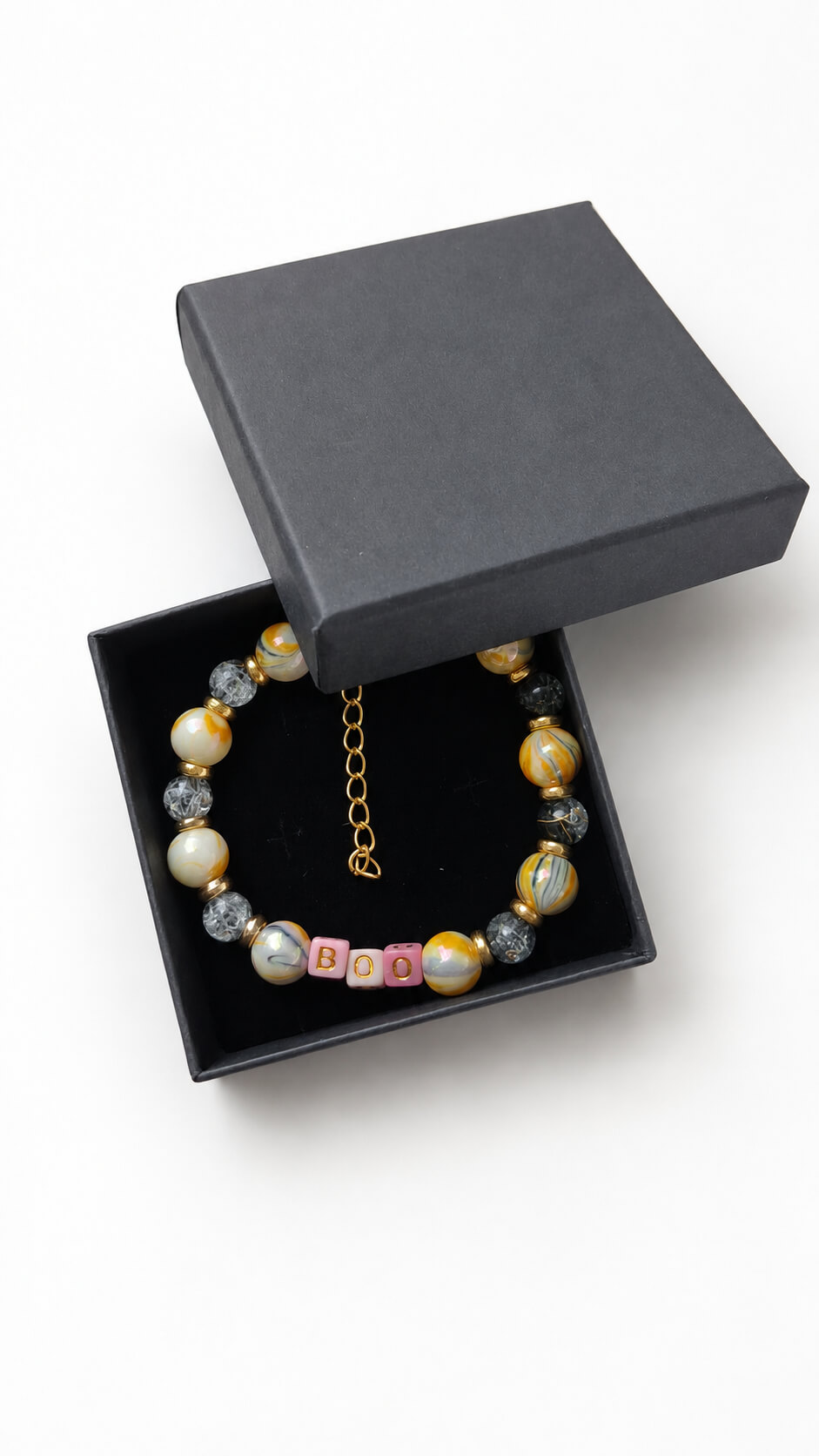 Handmade Halloween BOO beaded bracelet presented inside a black gift box with gold-toned extender chain
