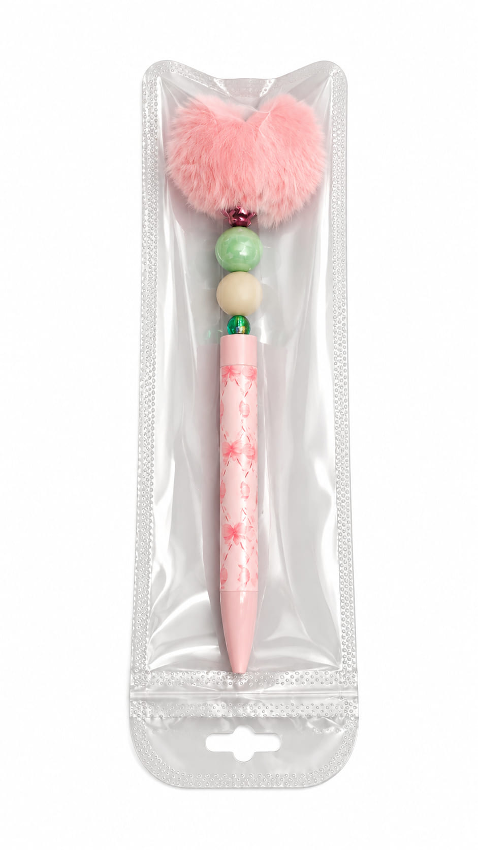 The Blush Bloom Custom Beaded Pen by Sparkling Resin Delights, topped with a fluffy pink pom pom and sage green beads, sealed in clear protective retail packaging.