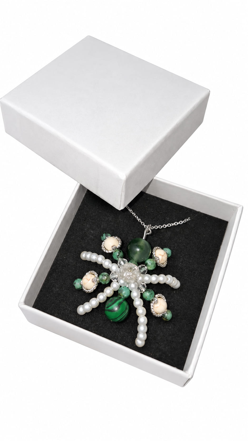 Sterling silver gemstone starburst necklace with green natural stones and Austrian crystals presented in a white jewellery gift box.