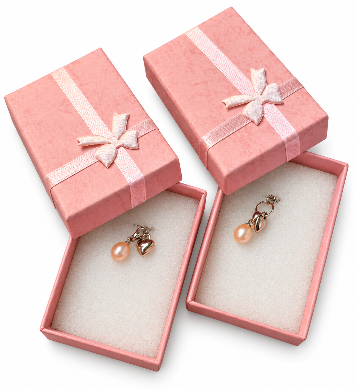Two open pink textured gift boxes with satin bows showing a set of two handmade sterling silver wedding charms featuring genuine pink freshwater pearls and silver hearts on white foam inserts.