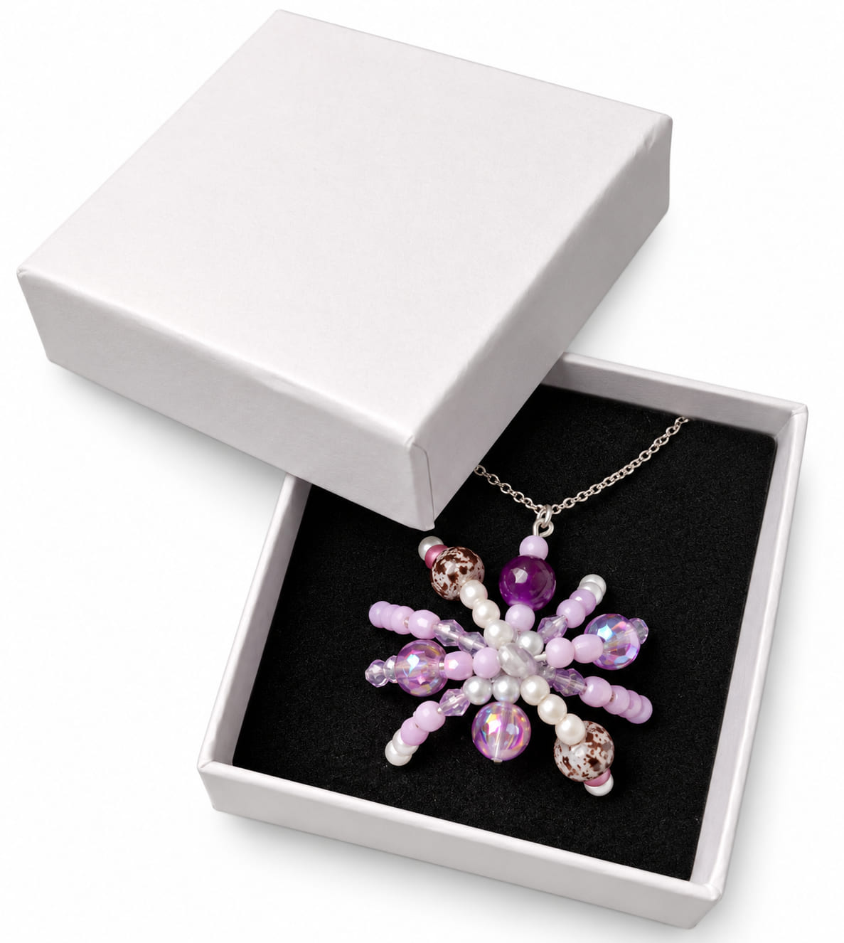 Purple beaded spider necklace presented in a white jewellery gift box with black insert.