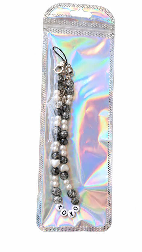 Handmade XOXO black and white beaded walking stick charm presented in a holographic gift pouch