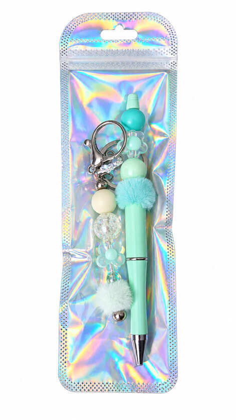 A mint green beaded pen and matching butterfly charm keychain set displayed inside a glossy, iridescent holographic retail pouch.