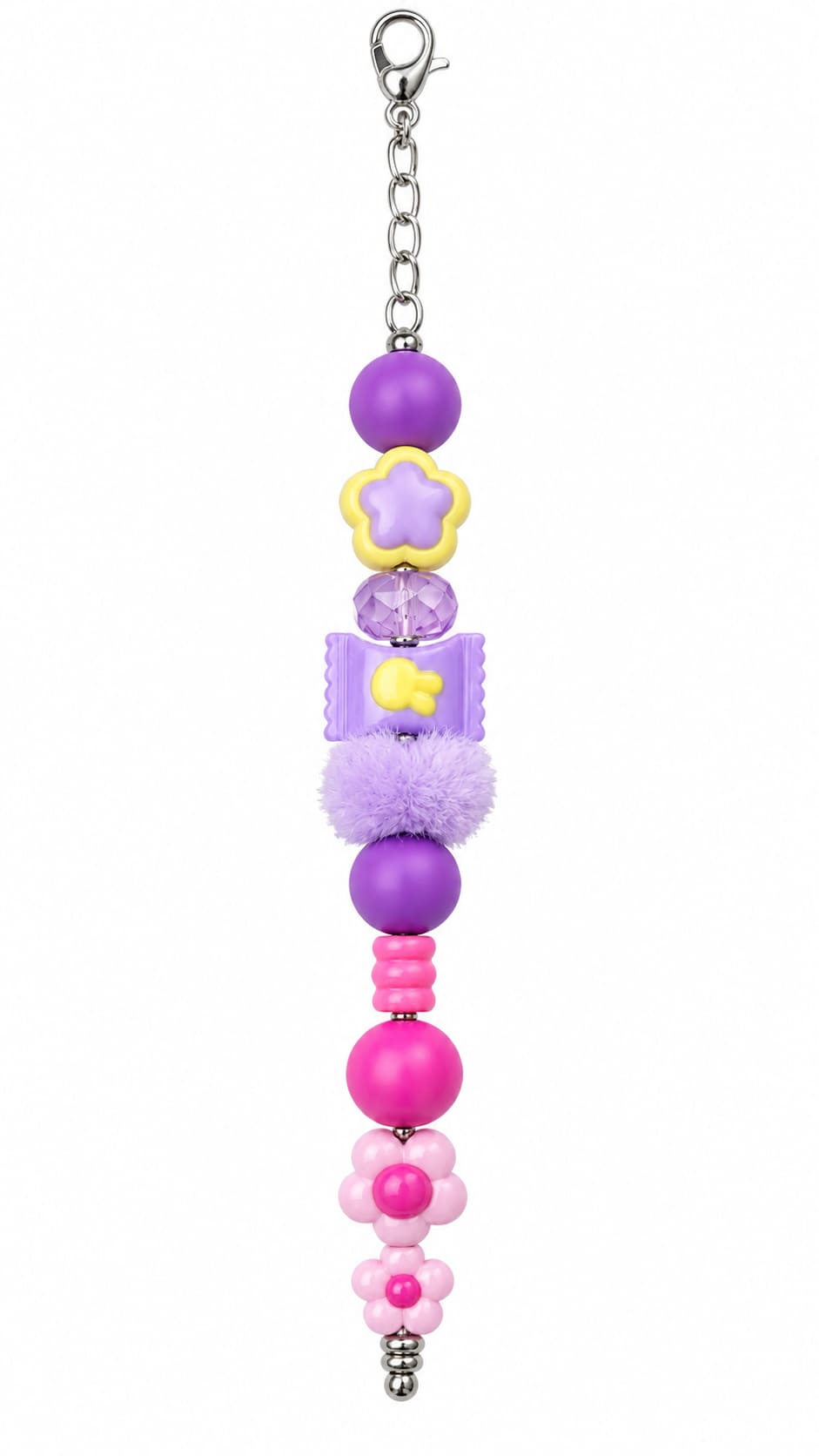 A close-up view of a novelty pastel fidget charm showing stacked purple and pink silicone beads, a yellow star flower, a purple candy bead with a bunny motif, a fluffy lilac pom-pom, and two pink blossom charms on a silver clasp