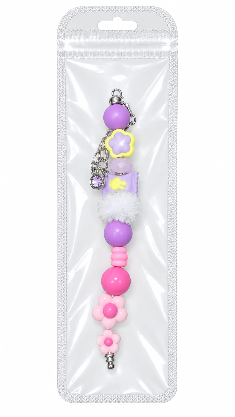 A pastel lilac candy and pink flower silicone beaded fidget charm with a purple gem accent, displayed inside a clear, professional retail plastic pouch with a hanging tab.