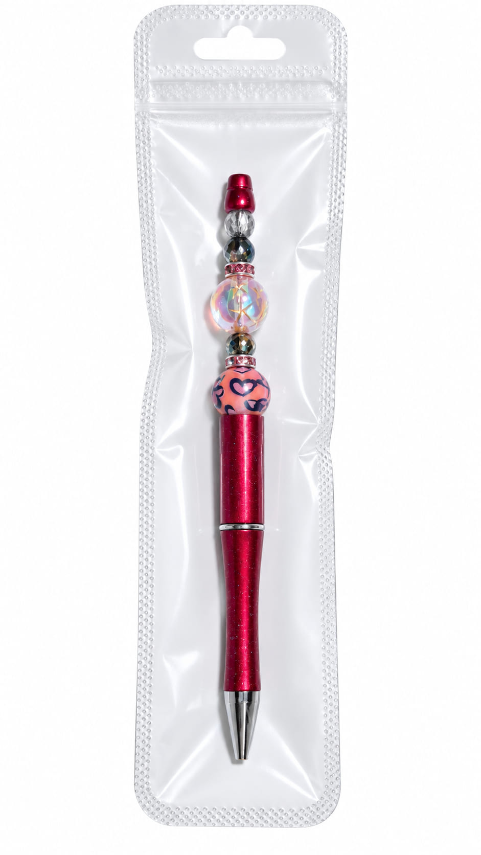 A luxury crimson red beaded pen with a leopard print focal bead displayed inside a long, clear, professional retail plastic pouch with a hanging tab.