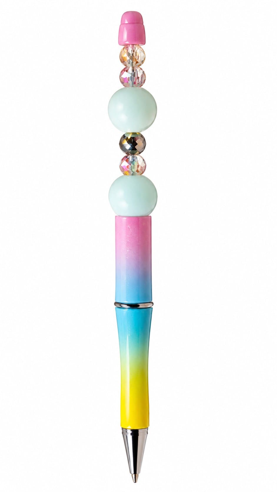 A close-up view of a custom ballpoint pen with a pink, blue, and yellow ombre glitter finish, decorated with milky pastel mint-blue beads, iridescent crystal faceted spacers, and a solid pink top cap.