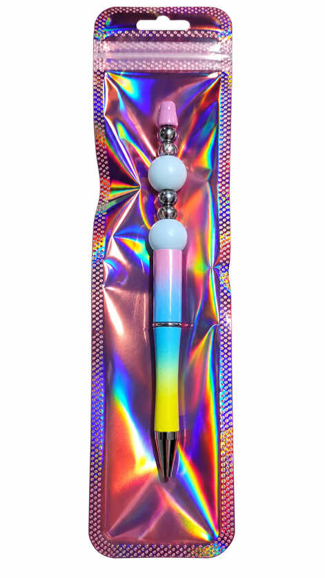 A cute pastel pink, blue, and yellow ombre beaded pen displayed inside a long, shimmering, iridescent holographic retail pouch.