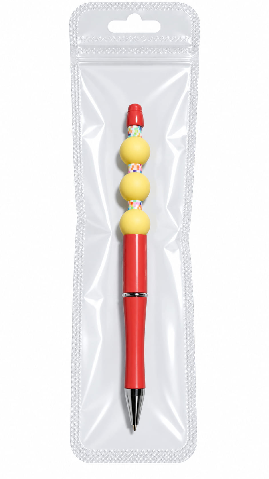 A custom red ballpoint pen with three matte yellow beads and multi-colored checkered spacers, displayed inside a long, clear, professional retail plastic pouch.