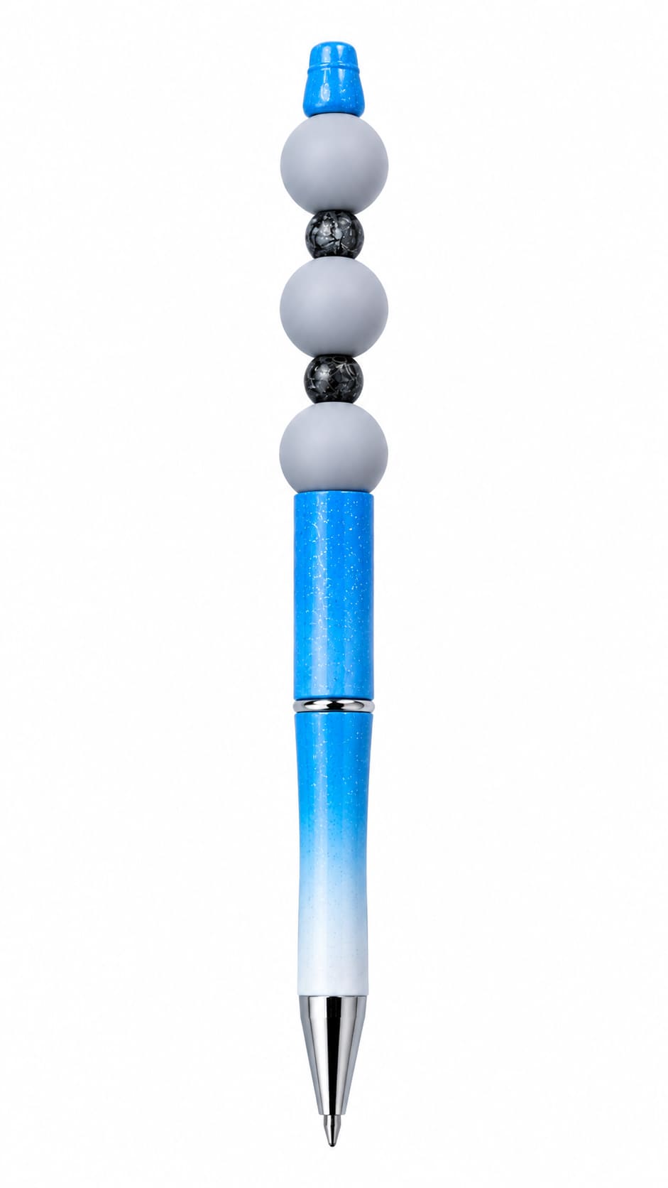A close-up view of a custom ballpoint pen with a glittering blue-to-white ombre barrel finish, decorated with a silver tip, three smooth matte grey silicone beads, black textured crackle spacers, and a blue top cap.