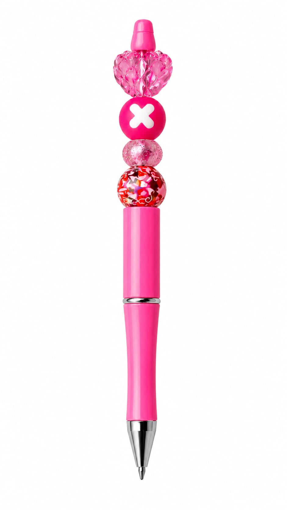 A close-up view of a custom hot pink ballpoint pen with silver trim, decorated with a colorful floral mosaic bead, a glittery pink spacer, a hot pink bead with a white X symbol, and a large faceted translucent heart topper.