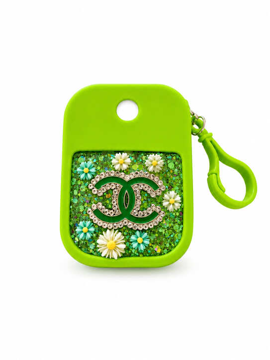 Lime green hand cleaner keychain holder decorated with resin, green glitter, flowers and sparkling crystal-style details