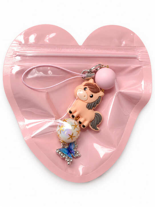 Adorable pink pony bridal party favour accessory with butterfly pendant packaged inside a decorative resealable pink heart-shaped gift pouch