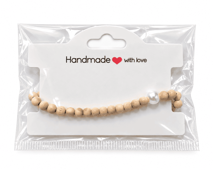 Natural wood and pearl-effect heart bracelet presented on a Handmade with love jewellery display card