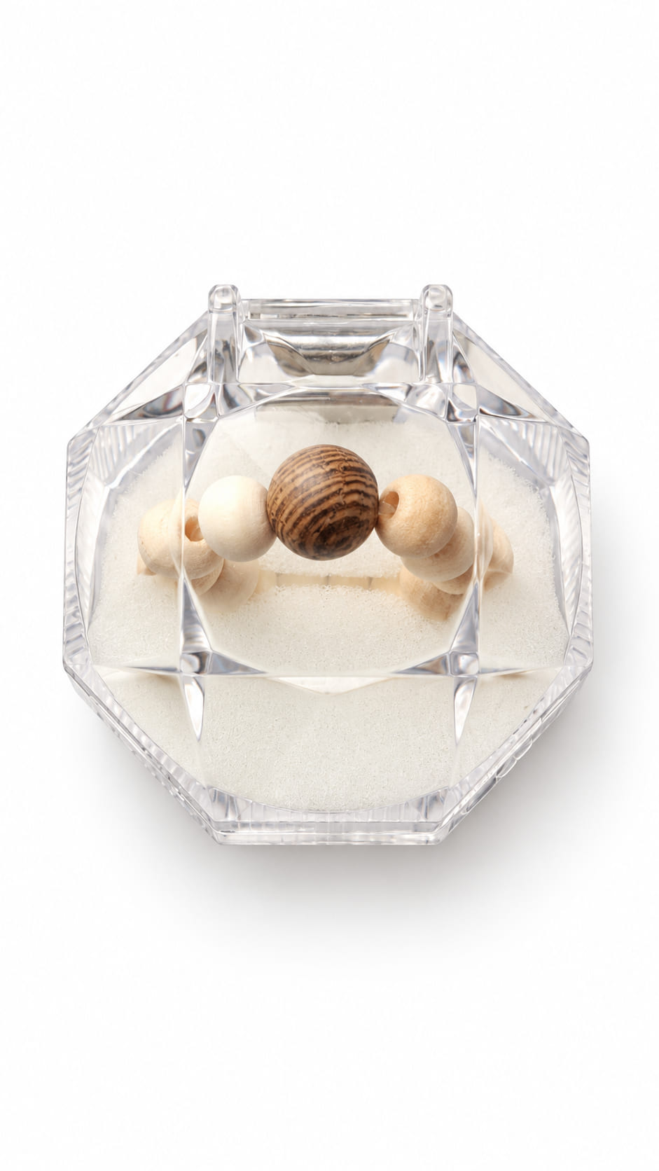 Natural wooden beaded stretch ring displayed inside a clear faceted jewellery box on a white background.