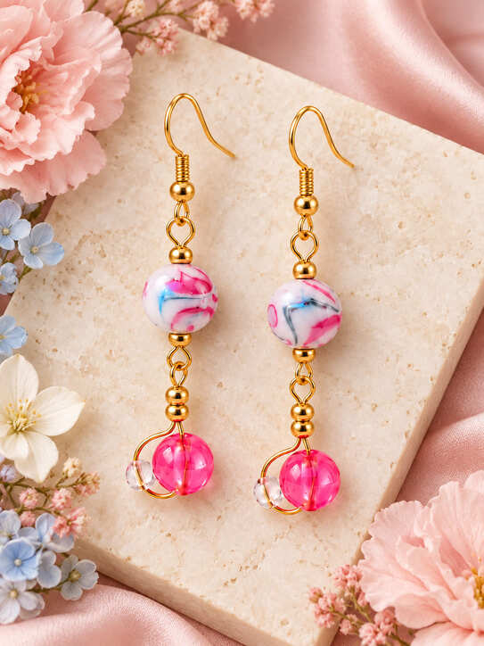 Pink Austrian crystal drop earrings in 18K gold-plated sterling silver styled with pink and blue flowers