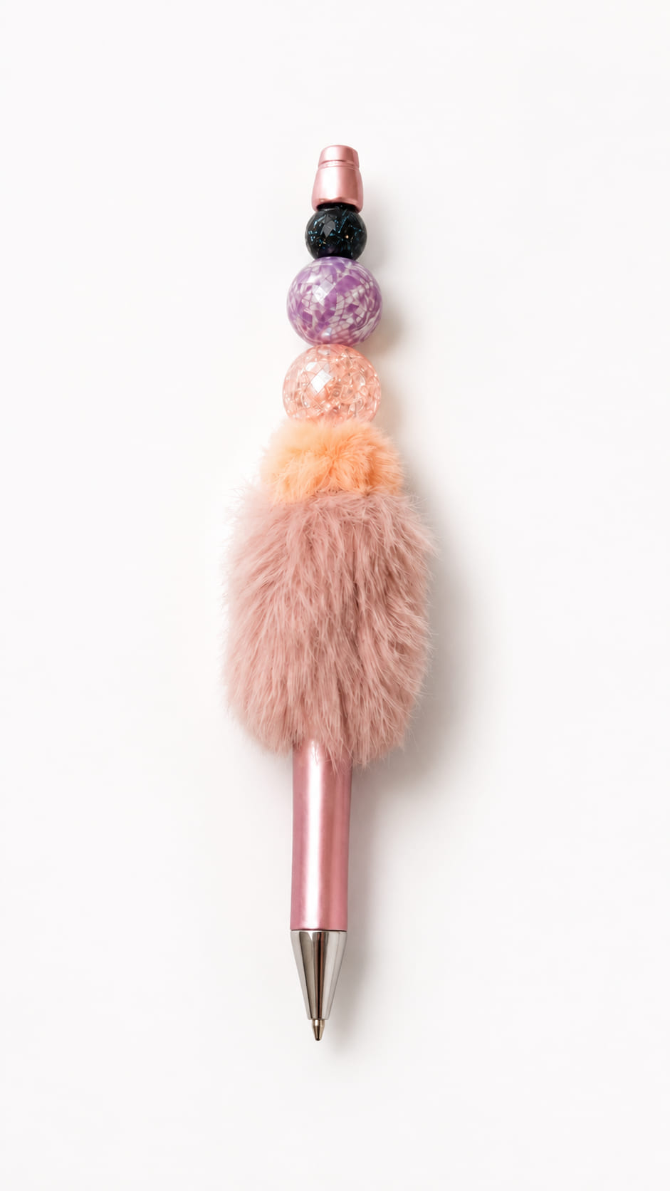 Handmade metallic pink ballpoint pen with purple, pink and sparkling beads and a soft fluffy pom-pom decoration.