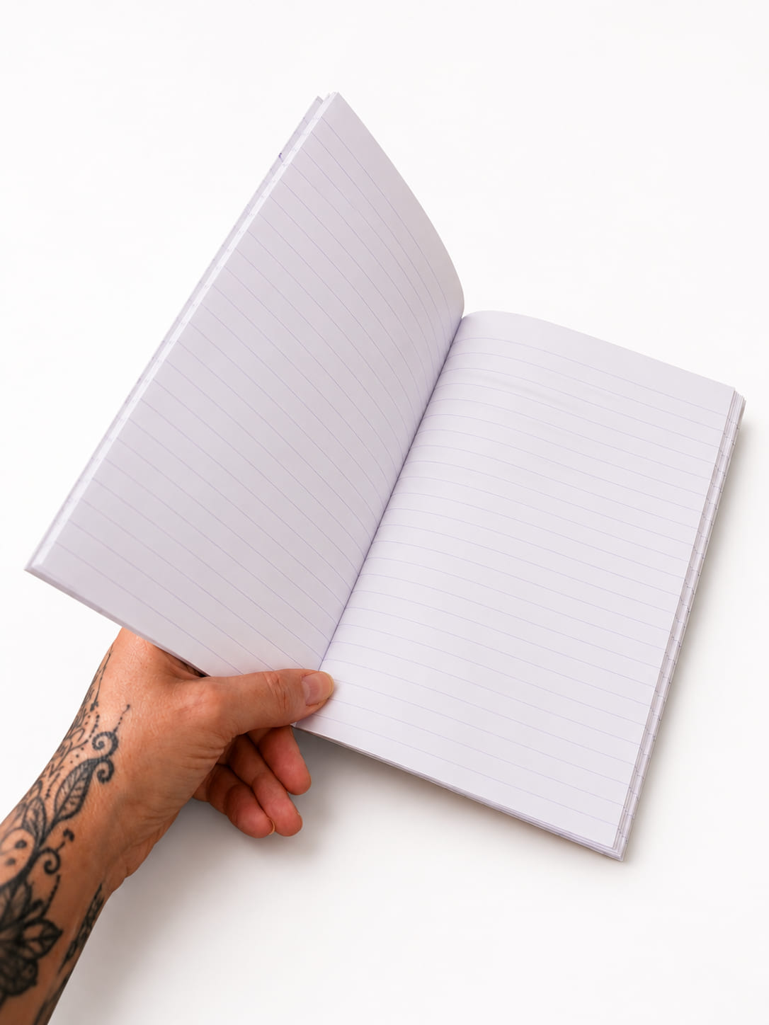 Open A5 purple notebook showing practical white lined pages for journalling, notes and planning.