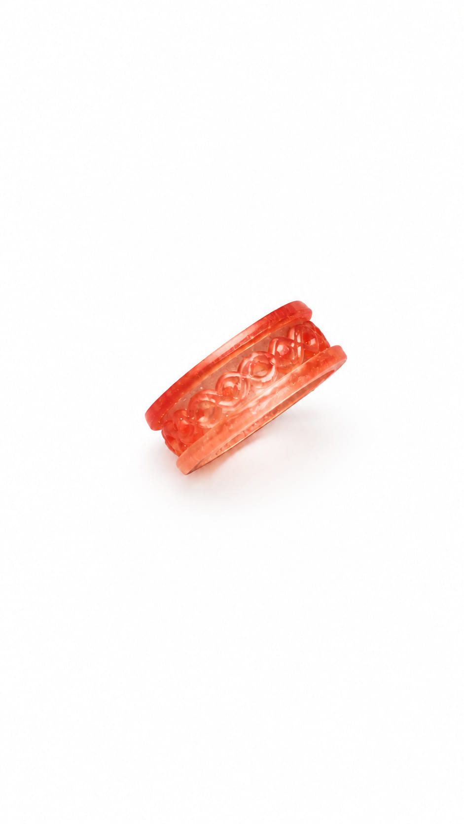 Handmade translucent coral pink epoxy resin ring with raised decorative knot pattern on a white background.