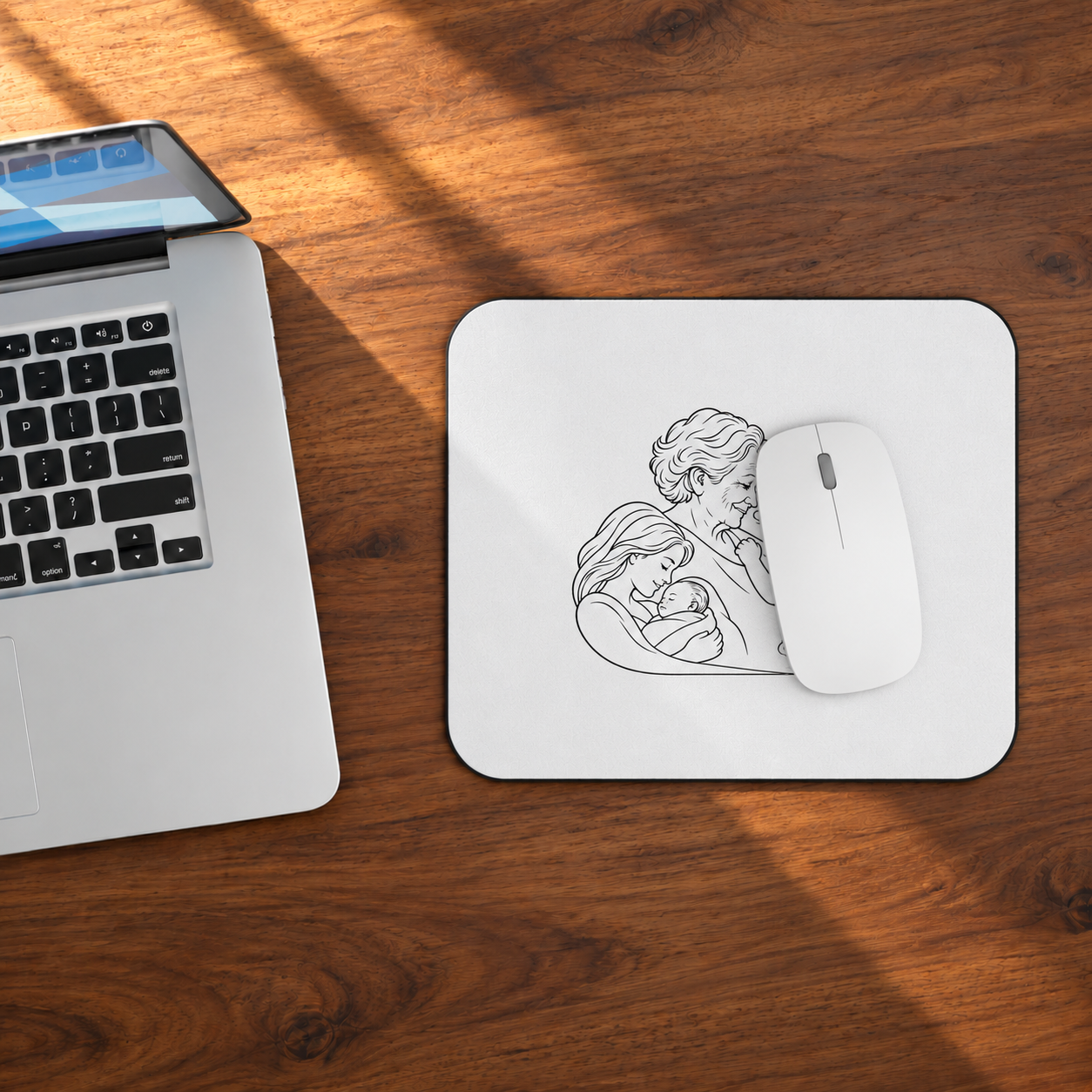Grandmother/Boy mouse pad beside a laptop on a wooden desk, with a white mouse resting on the printed artwork.