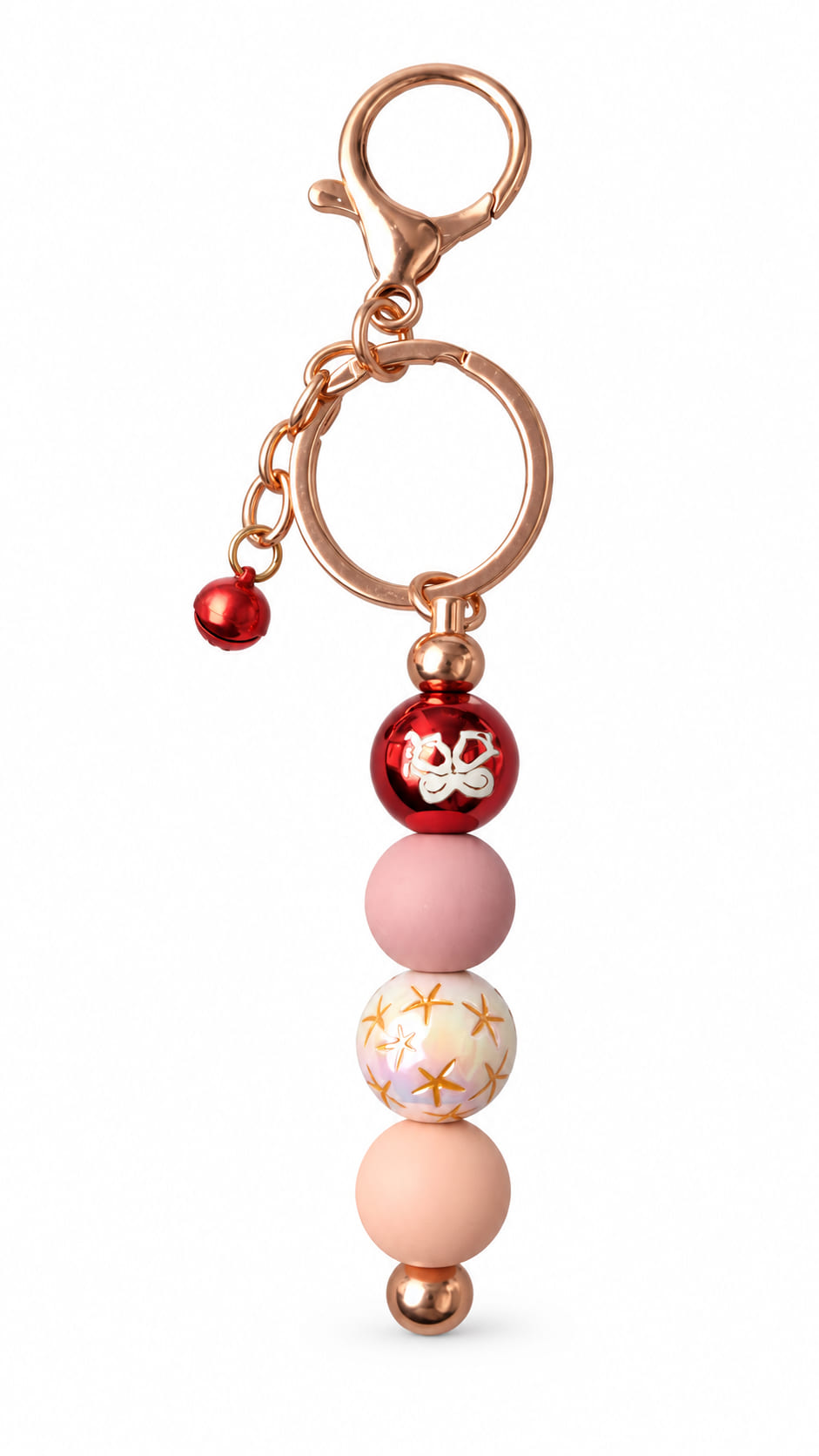 Handmade blush pink Christmas beaded keychain with red festive bead, pearl-style gold star bead, rose-gold-tone hardware and red jingle bell.